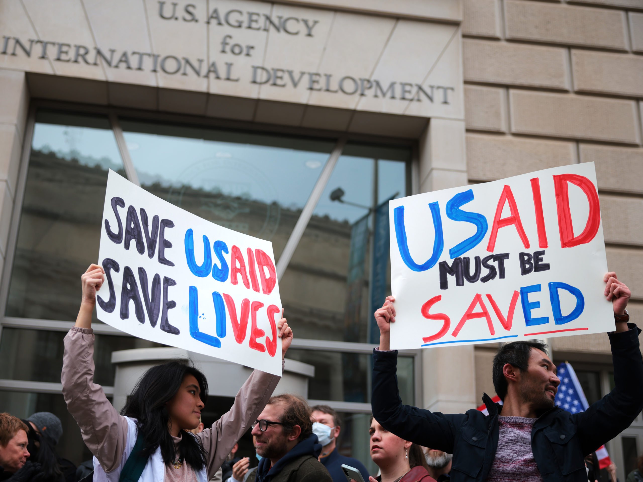 Protestors gather outside of USAID headquarters on February 03, 2025 in Washington, DC. Elon Musk, tech billionaire and head of the Department of Government Efficiency (DOGE), said in a social media post that he and U.S. President Donald Trump will shut down the foreign assistance agency. (Photo by Kayla Bartkowski/Getty Images)
