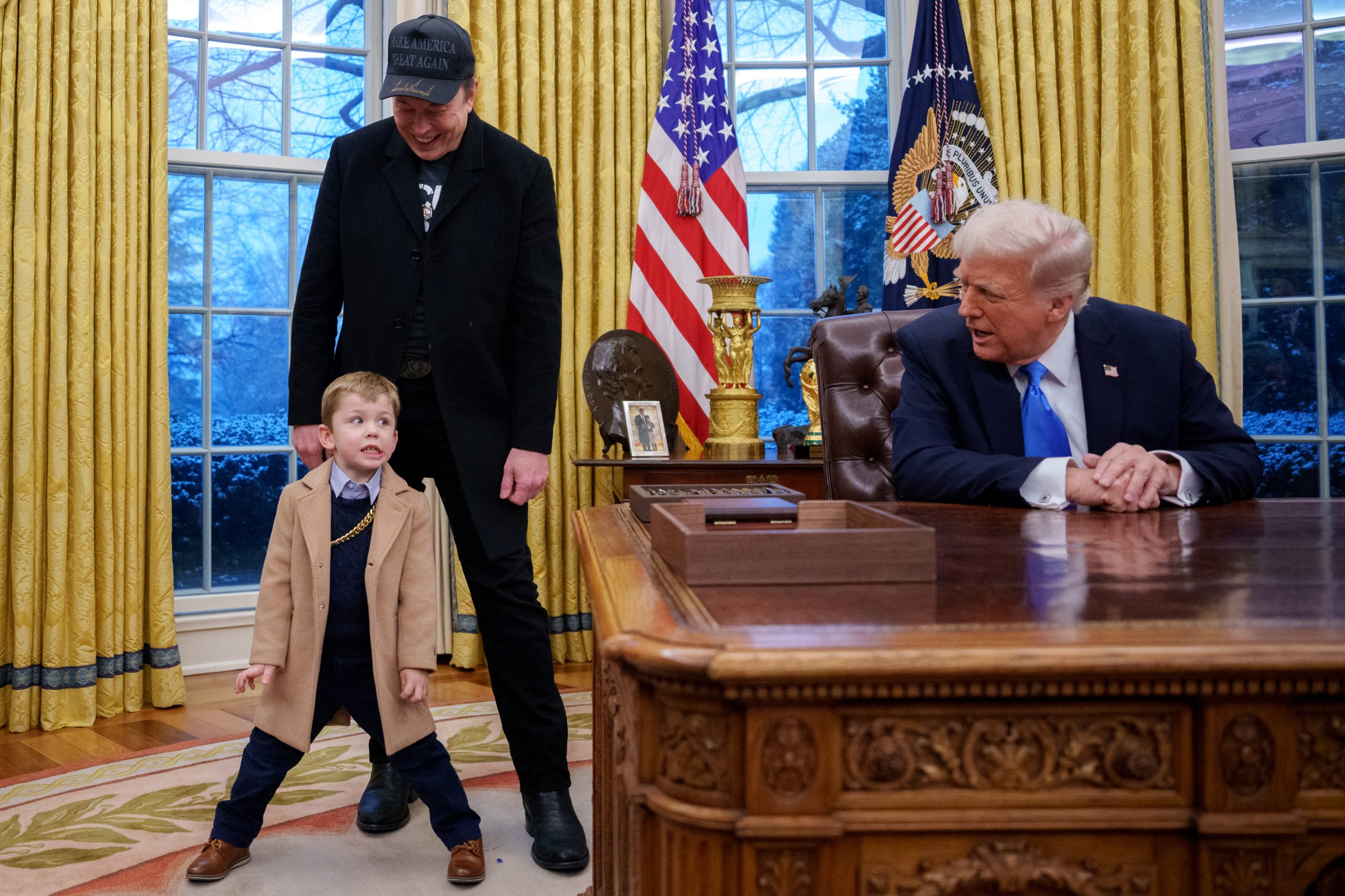 Tesla and SpaceX CEO Elon Musk, joined by his son "X", appears next to U.S. President Donald Trump as he speaks during an executive order signing in the Oval Office at the White House on February 11, 2025 in Washington, DC. Trump is to sign an executive order implementing the Department of Government Efficiency's (DOGE) "workforce optimization initiative," which, according to Trump, will encourage agencies to limit hiring and reduce the size of the federal government. (Photo by Andrew Harnik/Getty Images)
