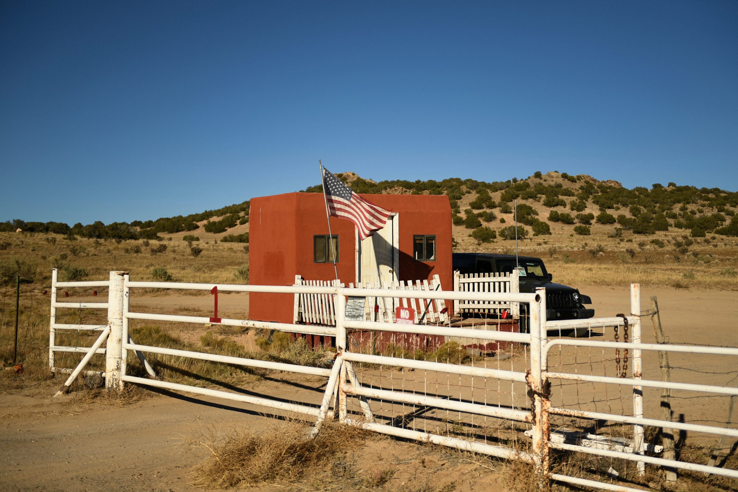 A US flag flies at the entrance to the Bonanza Creek Ranch film set, where a crew member was fatally shot during production of the western film "Rust", is seen on October 28, 2021 in Santa Fe, New Mexico. - The man who handed Alec Baldwin the gun that killed cinematographer Halyna Hutchins admitted he didn't fully check it, documents revealed on October 27, as the sheriff investigating the fatal shooting spoke of "complacency" on the US movie set. (Photo by Patrick T. FALLON / AFP) (Photo by PATRICK T. FALLON/AFP via Getty Images)