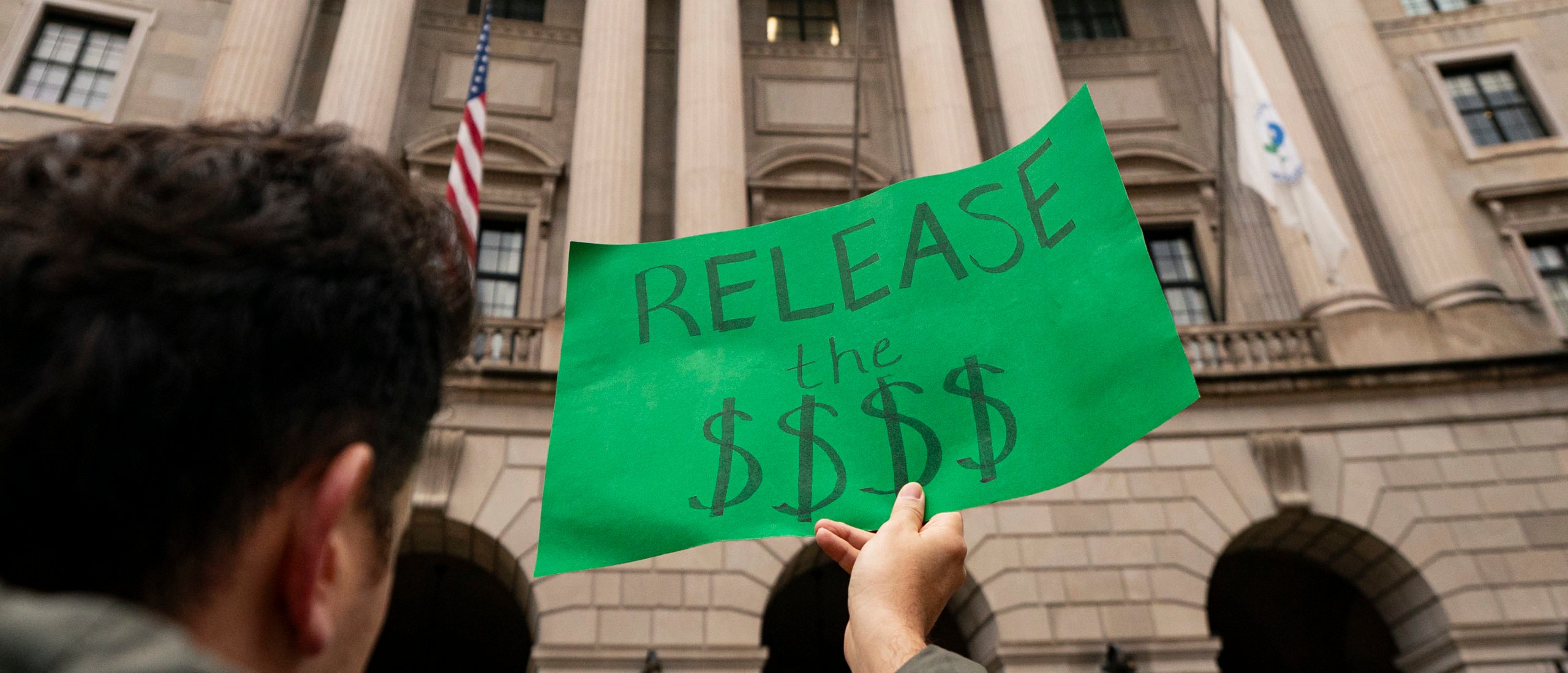 A demonstrator holds a sign during a demonstration following Sen. Edward Markey (D-MA) being blocked from entering the Environmental Protection Agency (EPA) to meet with Department of Government Efficiency (DOGE) officials, on February 6, 2025 in Washington, DC. (Photo by Al Drago/Getty Images)