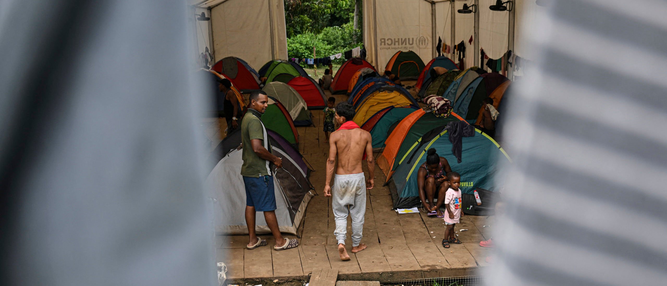 Migrants camp at the Reception Center for Migrant Care in Lajas Blancas, in the jungle province of Darien, Panama, on June 27, 2024. (Photo by MARTIN BERNETTI/AFP via Getty Images)
