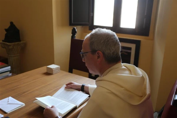 Dominican Father Thomas Joseph White reads the thesis of then-Father Robert Prevost, now Pope Leo XIV, titled “The Role of the Local Prior in the Order of St. Augustine,” which Prevost wrote while a student at Rome’s Pontifical University of St. Thomas Aquinas in the early 1980s. Credit: Zofia Czubak/EWTN News