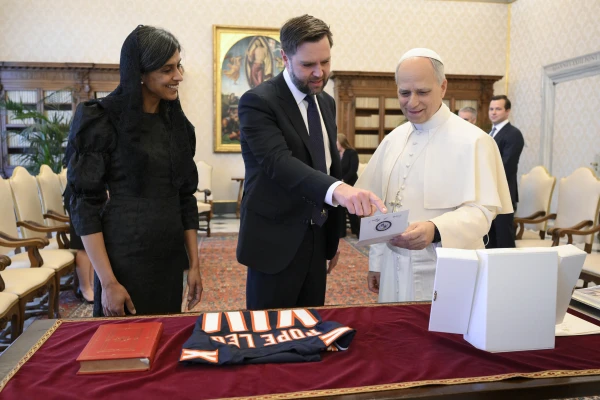 U.S. Vice President JD Vance and Second Lady Usha Vance show Pope Leo XIV the gifts they brought, including a Chicago Bears jersey with