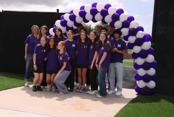 Students pose after being called to