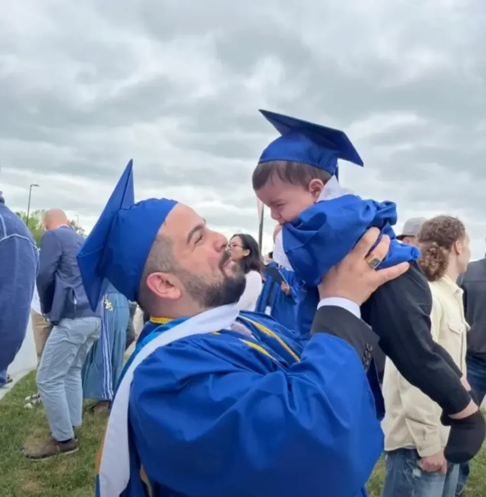 Chaotic Scene Unfolds as NY Graduate is chased on Stage by Police While Holding Infant Son [WATCH]