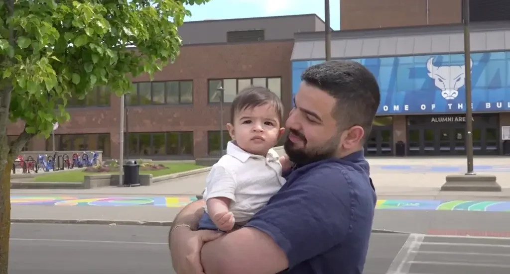 Chaotic Scene Unfolds as NY Graduate is chased on Stage by Police While Holding Infant Son [WATCH]