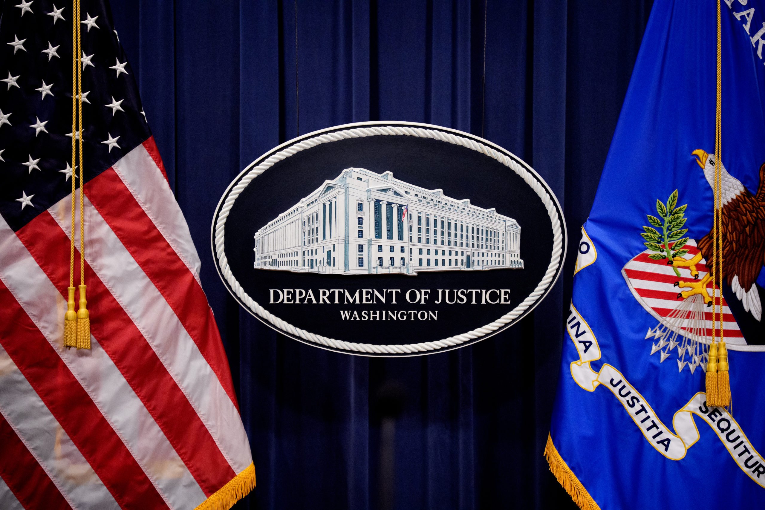 WASHINGTON, DC - MAY 6: The Department of Justice logo is displayed before U.S. Attorney General Pam Bondi arrives for a news conference at the Department of Justice on May 6, 2025 in Washington, DC. The Justice Department along with the Drug Enforcement Administration (DEA) and the U.S. Attorney's Office for the District of New Mexico are set to announce that they have completed an operation targeting a large drug trafficking organization that has been dealing fentanyl and other illicit narcotics. (Photo by Andrew Harnik/Getty Images)