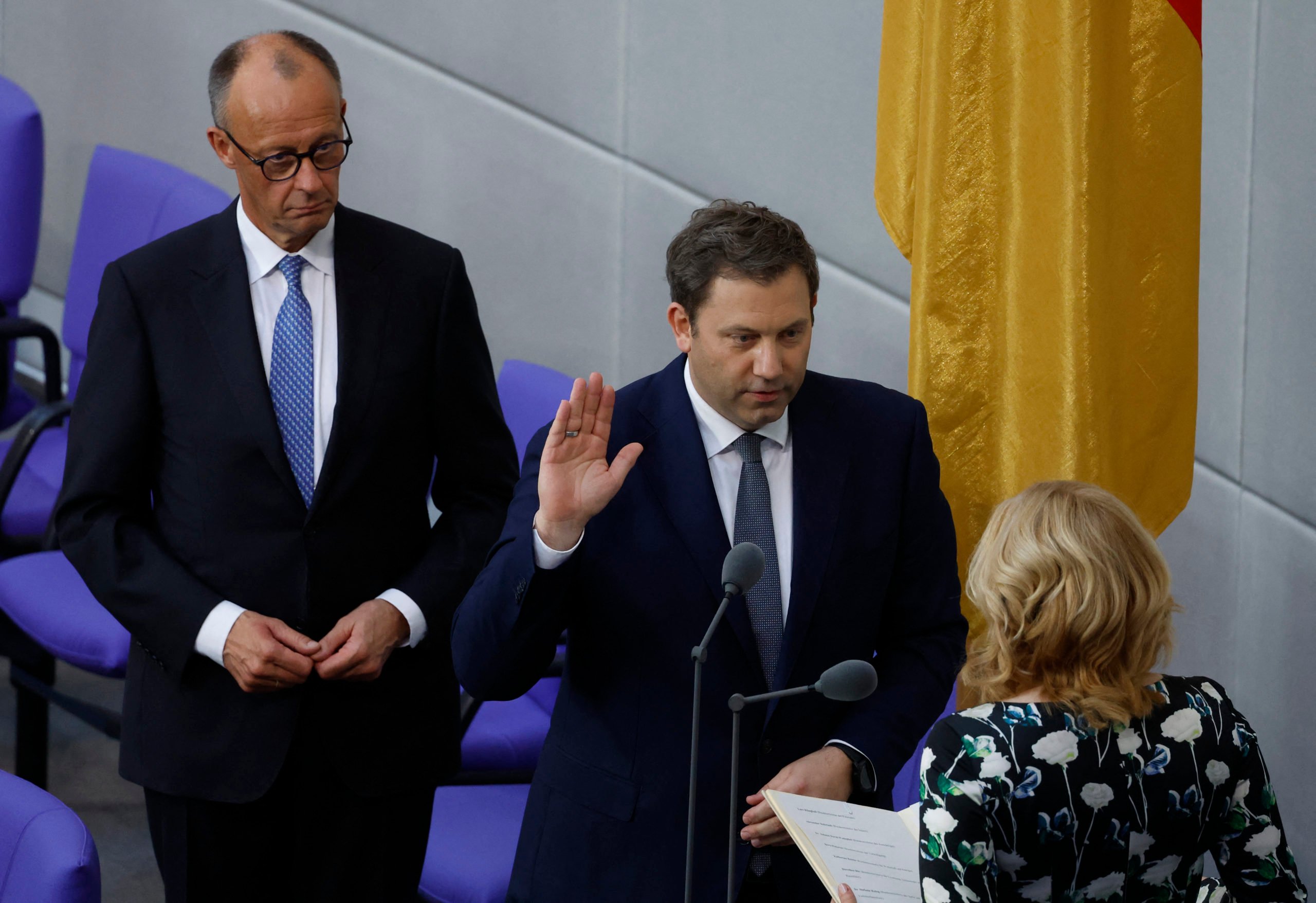 Designated German Finance Minister and Vice Chancellor Lars Klingbeil takes the oath from the President of the Bundestag (lower house of parliament) Julia Kloeckner next to German Chancellor Friedrich Merz (L) during a swearing in session after a second round of voting at the Bundestag (lower house of parliament) in Berlin on May 6, 2025. (Photo by ODD ANDERSEN/AFP via Getty Images)