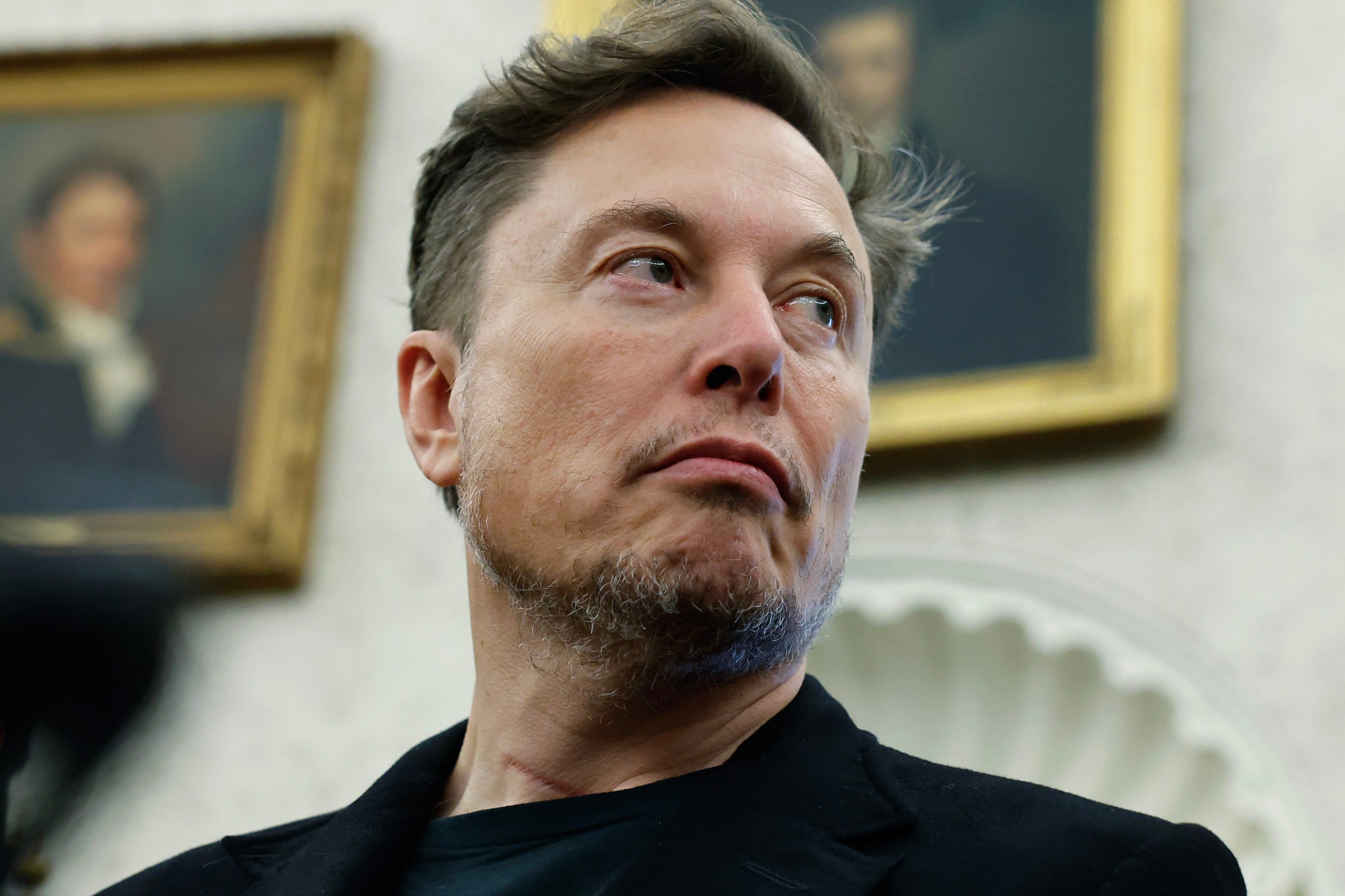 Elon Musk listens as reporters ask U.S. President Donald Trump and South Africa President Cyril Ramaphosa questions during a press availability in the Oval Office at the White House on May 21, 2025. (Photo by Chip Somodevilla/Getty Images)