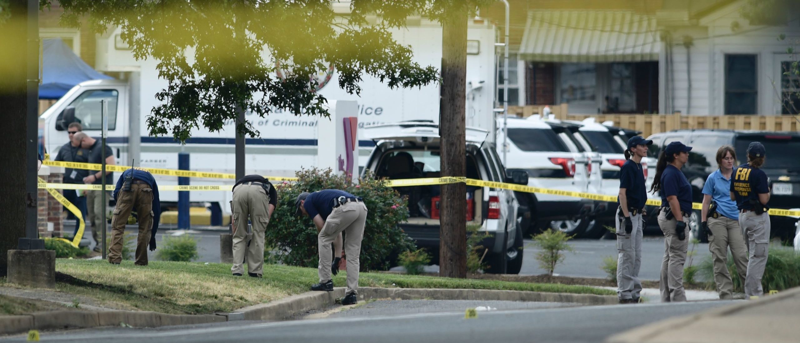 Members of the FBI collect evidences the crime scene after a shooting during a practice of the Republican congressional baseball at Eugene Simpson Statium Park June 14, 2017 in Alexandria, Virginia. At least five people people including a top Republican congressman were wounded in a Washington suburb early Wednesday morning when a shooting erupted as they practiced for an annual baseball game between lawmakers. Senior congressman Steve Scalise was shot in the hip, according to fellow Republican lawmaker Mo Brooks who told CNN at least two law enforcement officers and one congressional staffer were also shot in the incident in Alexandria, Virginia. (BRENDAN SMIALOWSKI/AFP via Getty Images)