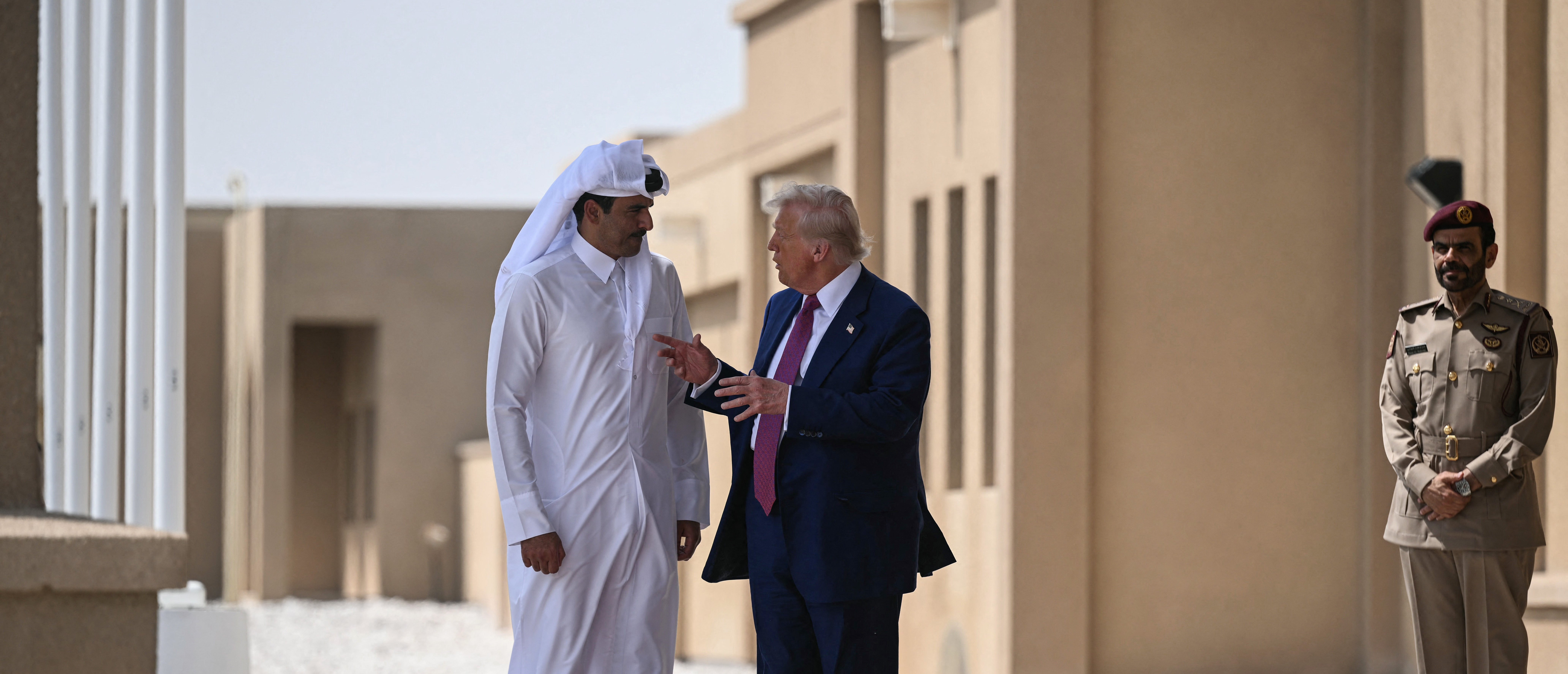 Qatar's Emir Sheikh Tamim bin Hamad al-Thani (L) talks to US President Donald Trump at the end of the Qatari leg of his regional tour, at the Al-Udeid air base southwest of Doha on May 15, 2025. (Photo by BRENDAN SMIALOWSKI/AFP via Getty Images)