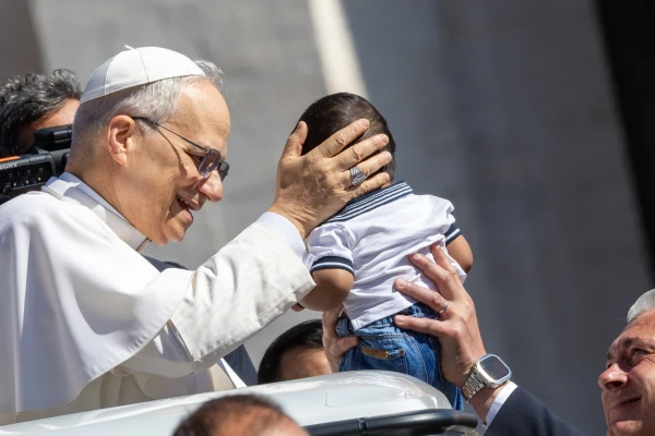Pope Leo XIV blesses a baby during his general audience on Wednesday, May 28, 2025, in St. Peter’s Square at the Vatican. Credit: Daniel Ibañez/CNA
