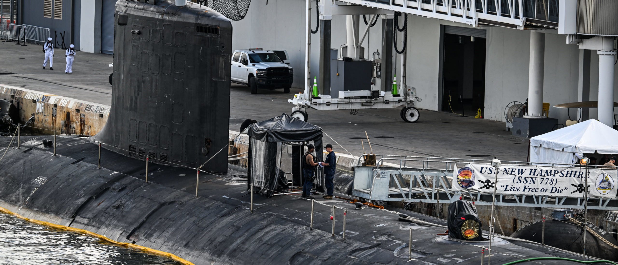 US Navy personnel stand a top USS New Hampshire (SSN-778), a Virginia-class nuclear-powered attack submarine at Port Everglades in Fort Lauderdale, Florida, on April 29, 2025. (Photo by CHANDAN KHANNA/AFP via Getty Images)
