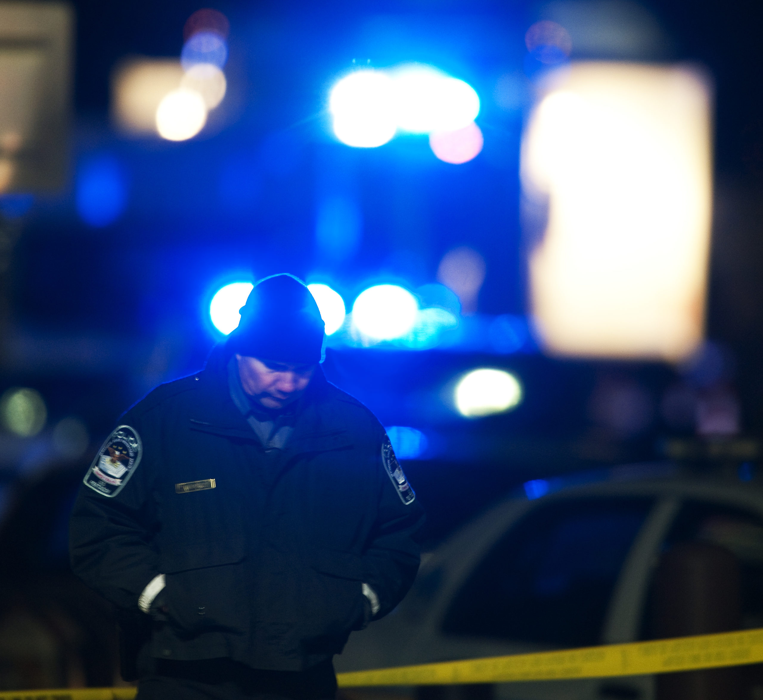 Lights from police vehicles flash in the background as a Pentagon police officer PAUL J. RICHARDS/AFP via Getty Images)