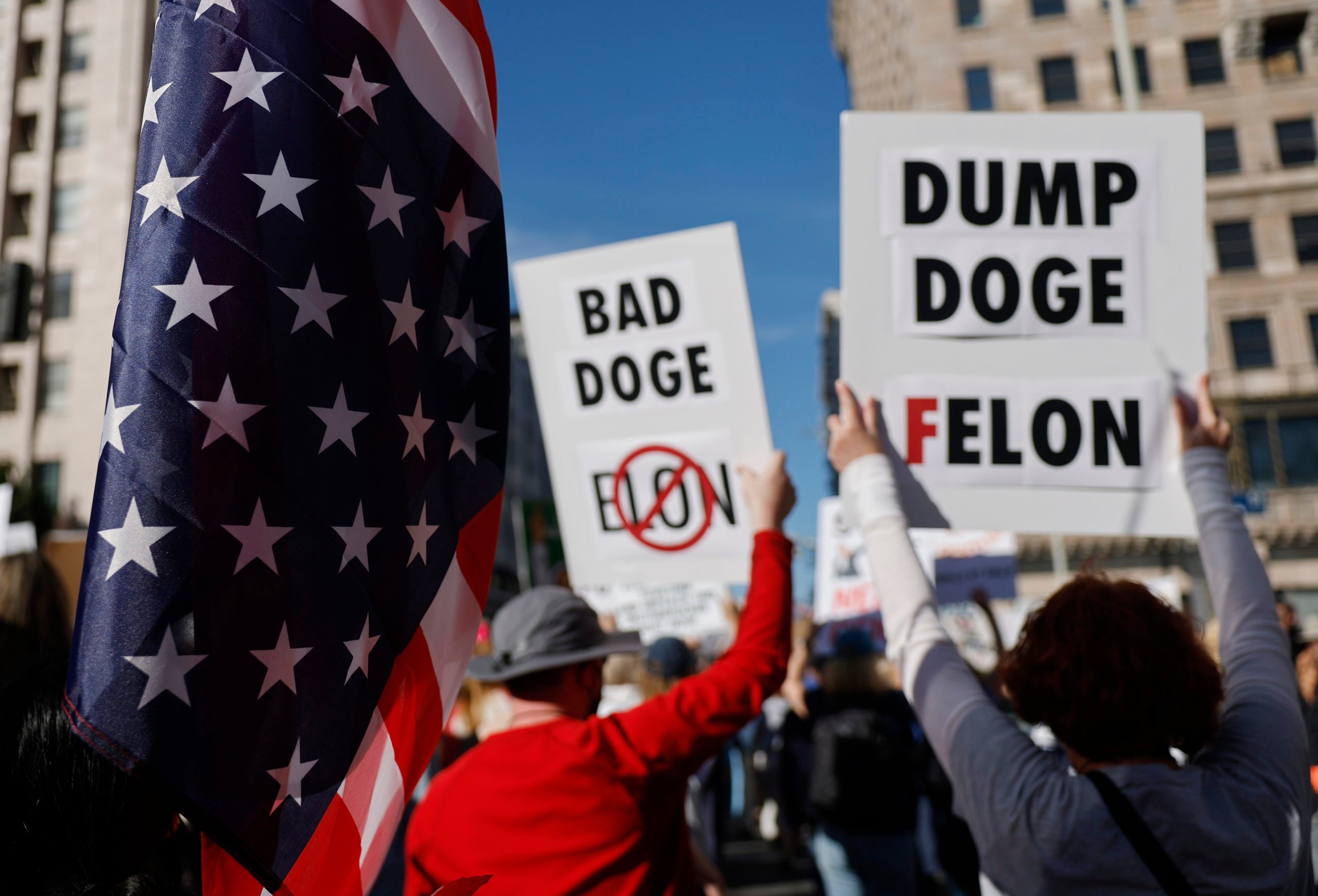 LOS ANGELES, CALIFORNIA - APRIL 05: Protestors demonstrate holding signs referring to DOGE at a 'Hands Off!' protest against the Trump administration on April 5, 2025 in Los Angeles, California. Protests against Trump administration policies and Elon Musk's Department of Government Efficiency (DOGE) are being held nationwide in what organizers are calling a National Day of Action. (Photo by Mario Tama/Getty Images)