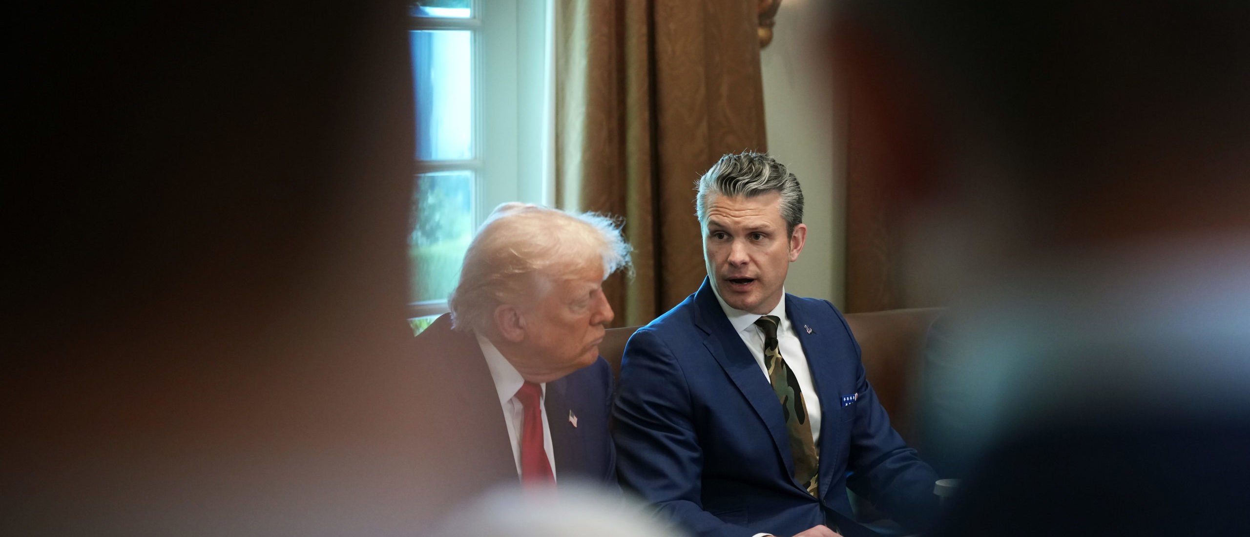 U.S. Defense Secretary Pete Hegseth (R) speaks as U.S. President Donald Trump looks on during a Cabinet meeting at the White House on April 30, 2025 in Washington, DC. Trump convened the meeting as reports released today say the U.S. economy contracted 0.3% in the first quarter of 2025, the first negative reading in three years, fueled by a massive surge in imports ahead of the administration's expected tariffs. (Photo by Andrew Harnik/Getty Images)