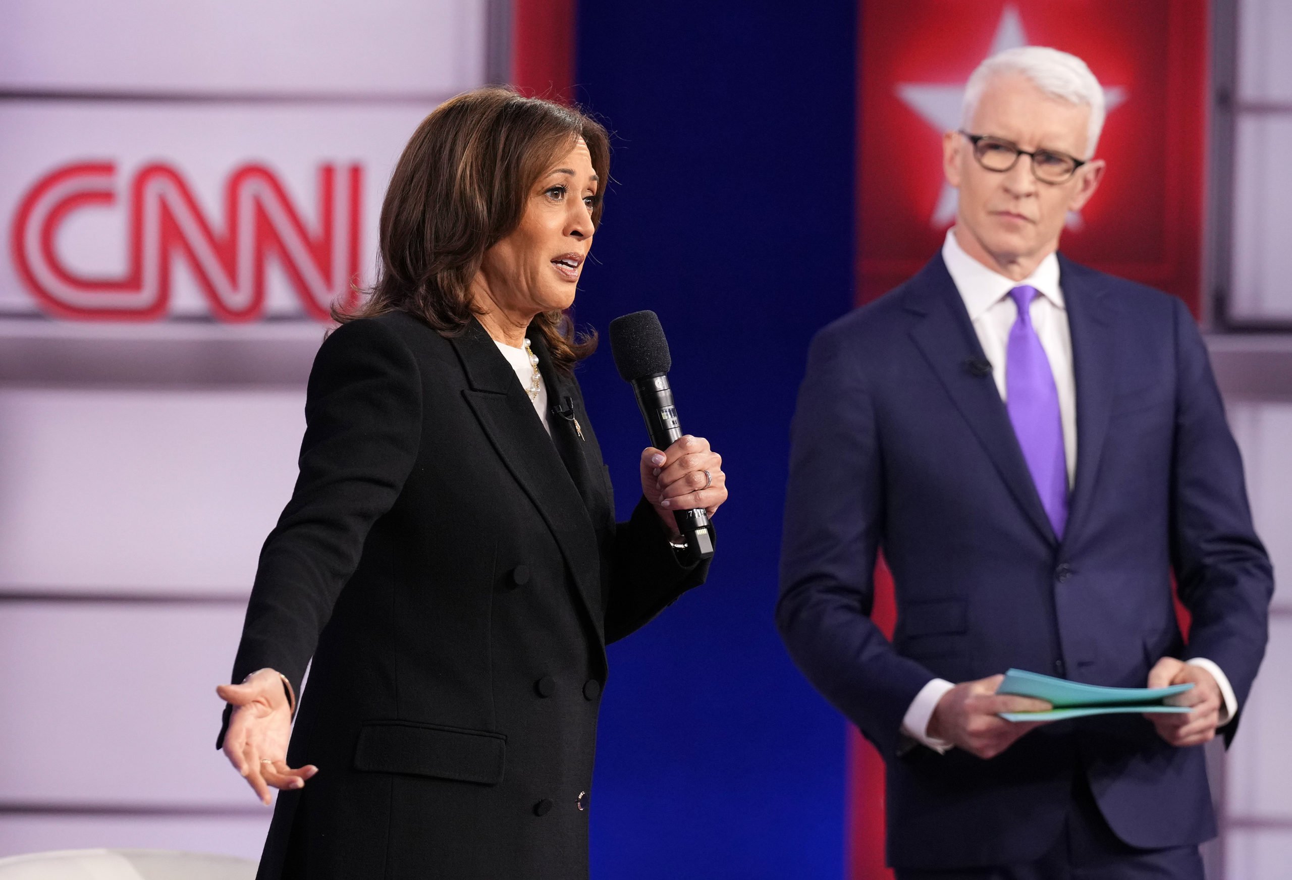 Democratic presidential nominee, U.S. Vice President Kamala Harris (L) speaks as CNN moderator Anderson Cooper looks on during a Presidential Town Hall at Sun Center Studios on October 23, 2024 in Aston, Pennsylvania. (Photo by Andrew Harnik/Getty Images)