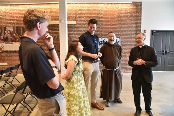 Archbishop Charles Coleman Thompson of Indianapolis and Father Christopher Iwancio with three of the perpetual pilgrims — (left to right) Stephen Fuhrann, Leslie Reyes-Hernandez, and Charlie McCullough. Credit: Sean Gallagher/The Criterion