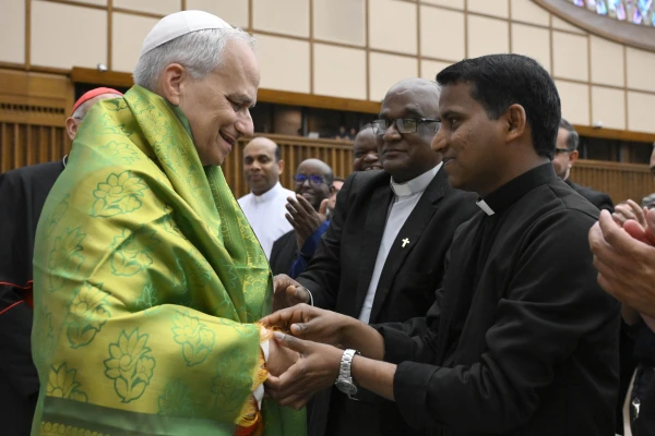 Pope Leo XIV greets a priest in the Vatican's Paul VI Audience Hall on Thursday, June 12, 2025. Credit: Vatican Media