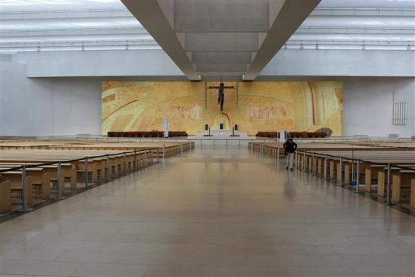 Rupnik mosaics cover the back wall of the Basilica of the Holy Trinity, the most modern of the churches at the Shrine of Our Lady of Fatima, in Portugal. The approximately 33-by-164-foot gold mosaic was installed in 2007 and features the paschal lamb at the center. Credit: Daniel Ibanez/CNA