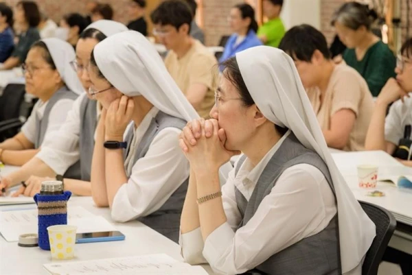 Religious sisters and laypeople join in a symposium organized by the Church in Korea on the
