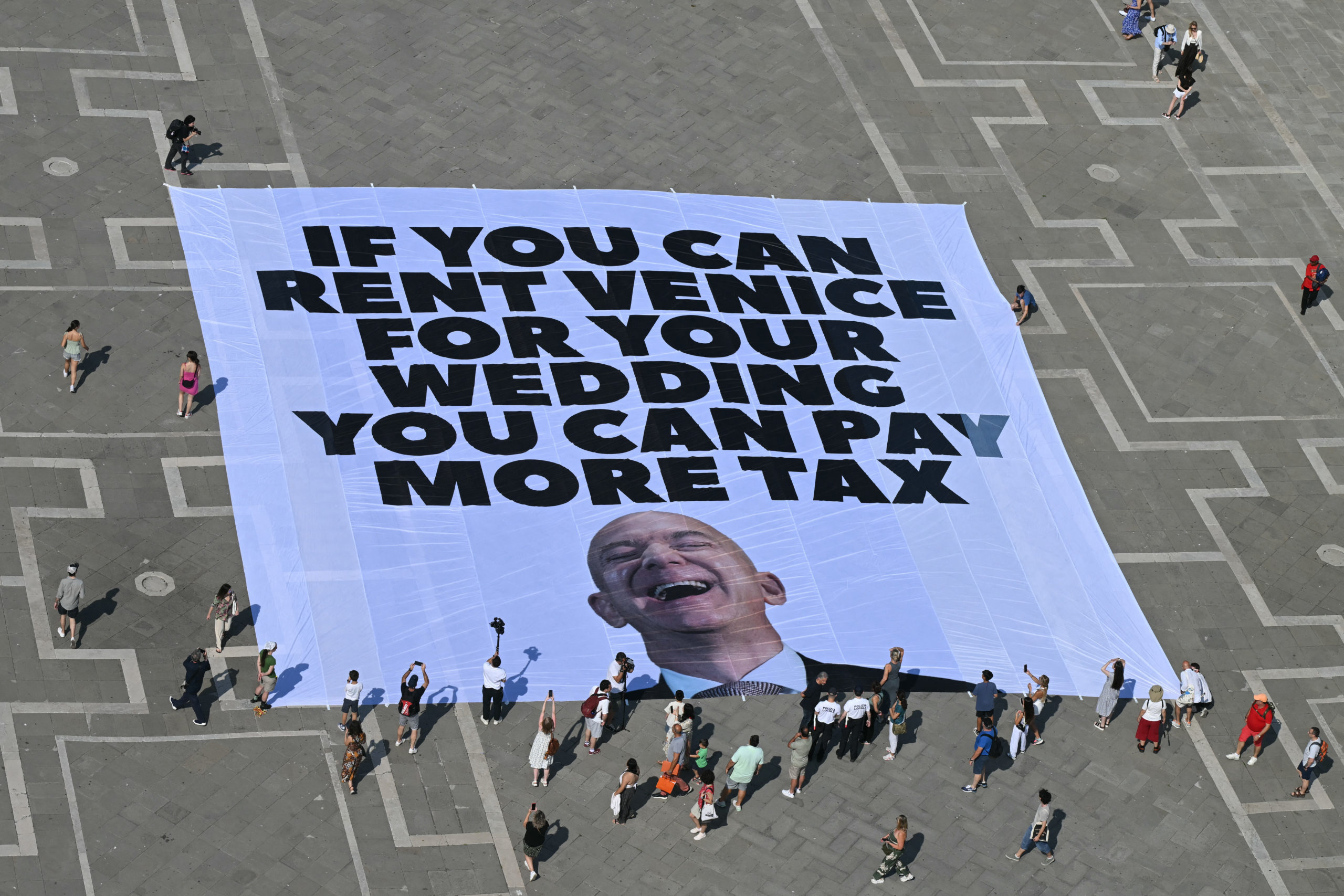 Activists of international environmental group Greenpeace deploy a giant banner displaying a picture of Jeff Bezos and reading