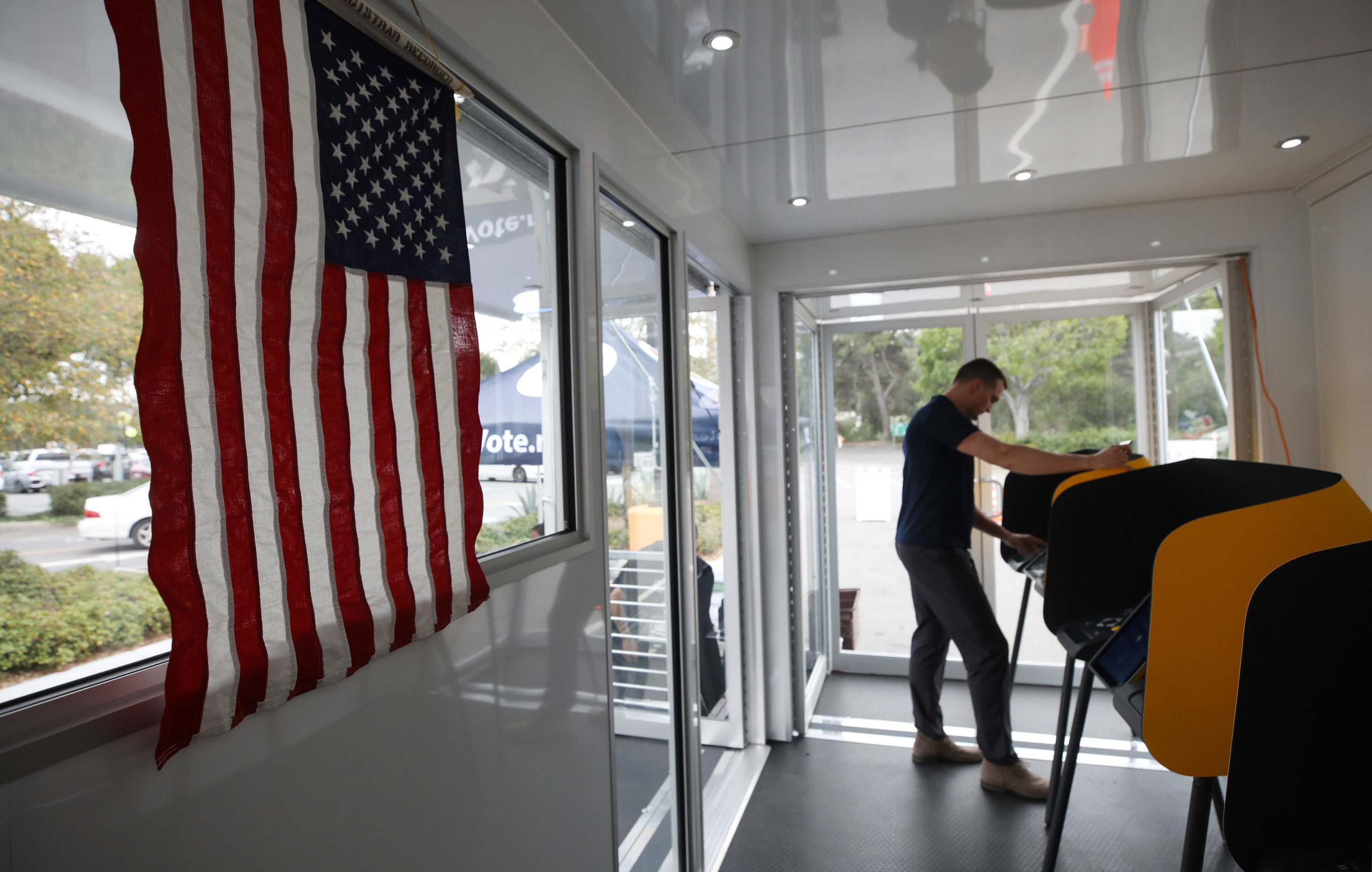 A voter prepares his ballot in a voting booth during early voting for the California presidential primary election. (Photo by Mario Tama/Getty Images)