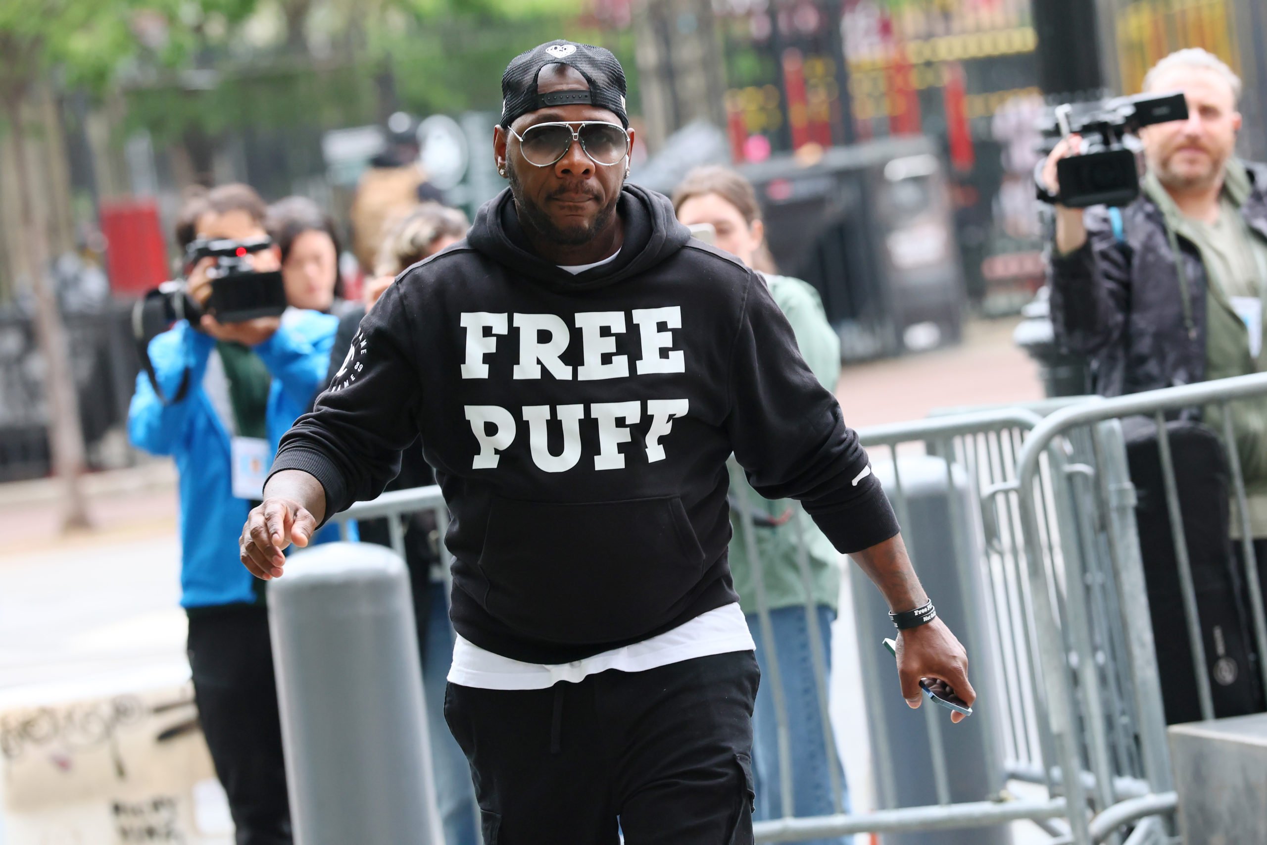NEW YORK, NEW YORK - MAY 05: A person wearing a "Free Puff" sweatshirt arrives for the start of the Sean "Diddy" Combs trial at Manhattan Federal Court on May 05, 2025 in New York City. Jury selection begins in Combs' trial, who has been charged with sex trafficking, racketeering conspiracy, and transporting to engage in prostitution. Combs has been in custody since his arrest last September and has pleaded not guilty on all charges. (Photo by Michael M. Santiago/Getty Images)