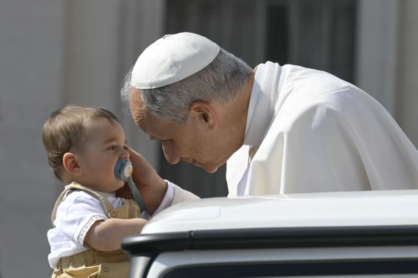 Pope Leo XIV blesses a baby during his general audience in St. Peter’s Square on June 18, 2025, at the Vatican. Credit: Vatican Media