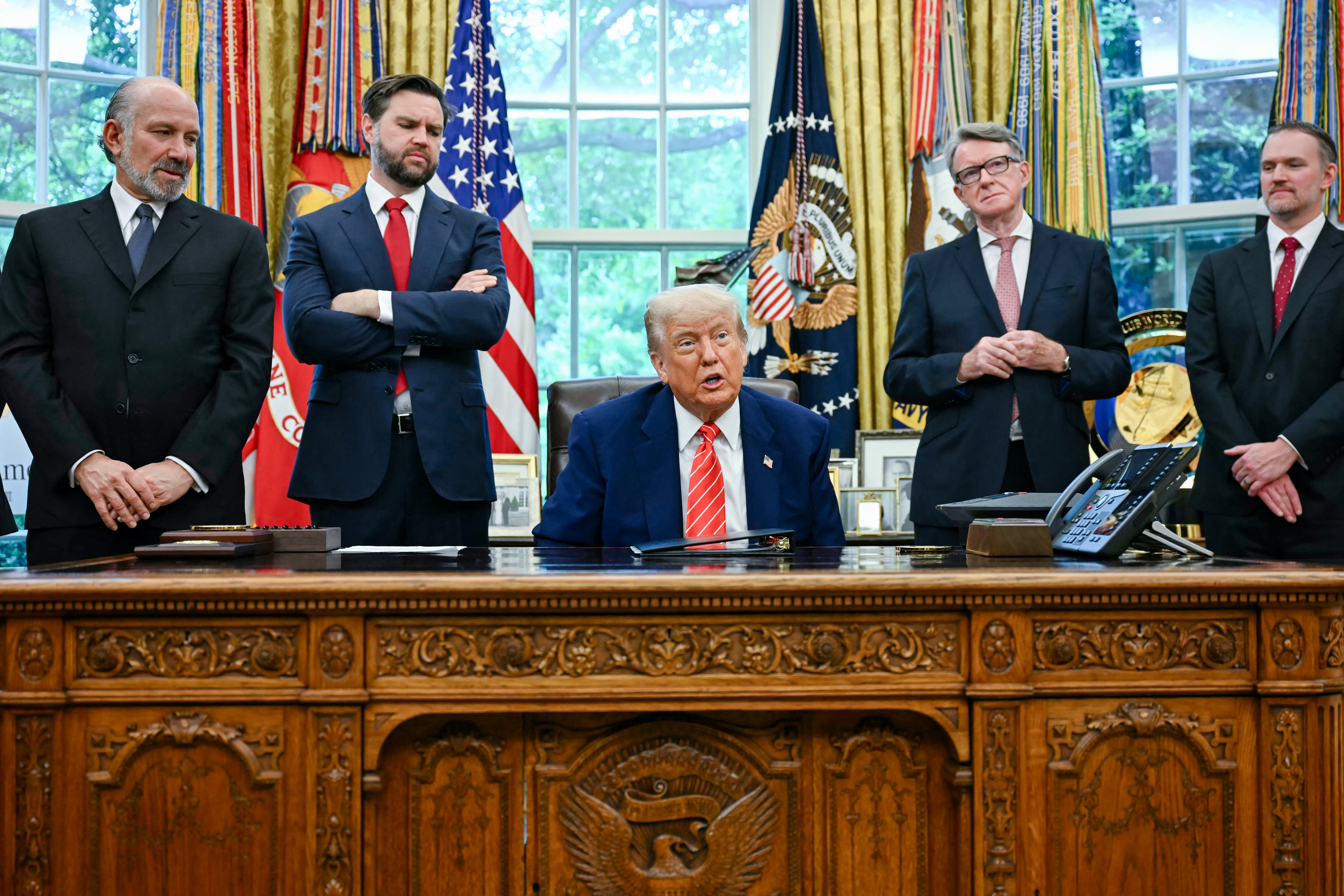 US President Donald Trump makes a trade announcement as US Secretary of Commerce Howard Lutnick (2L), US Vice President JD Vance (3L), British ambassador to the United States Peter Mandelson (2R), US Trade Representative Jamieson Greer (R) look on in the Oval Office of the White House in Washington, DC, on May 8, 2025. (Photo by JIM WATSON/AFP via Getty Images)