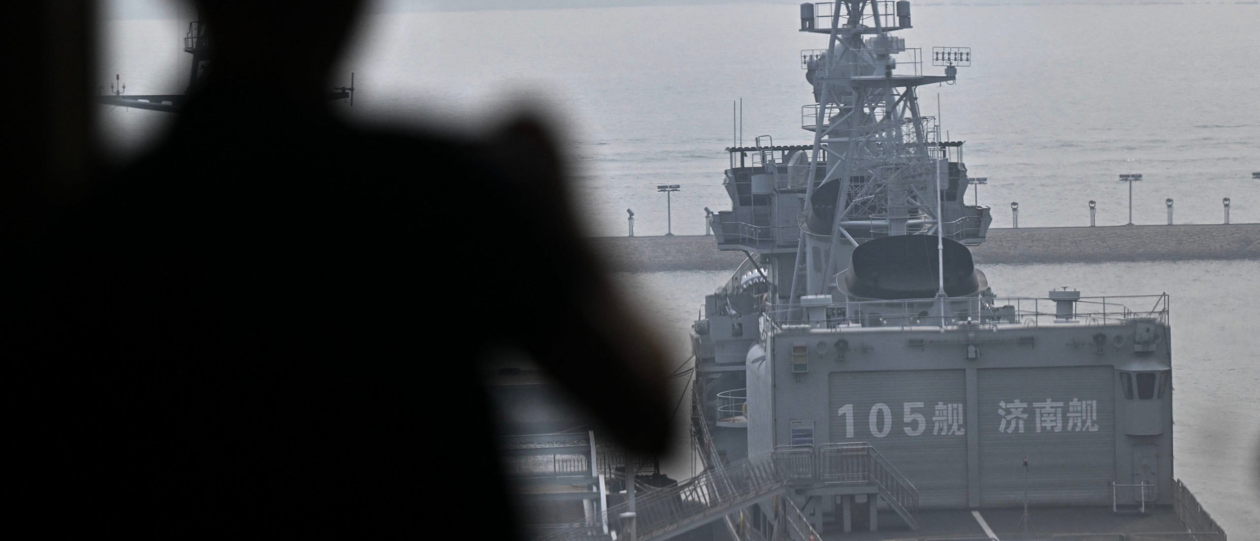 A journalist takes pictures of the Chinese Navy Jinan destroyer during a media tour by the PLA Naval Museum, organized by the Chinese People's Liberation Army Navy (PLAN) ahead to Defence Ministers' Meeting of the Shanghai Cooperation Organization (SCO) Member States in Qingdao, in eastern China's Shandong province on June 25, 2025. (Photo by PEDRO PARDO/AFP via Getty Images)