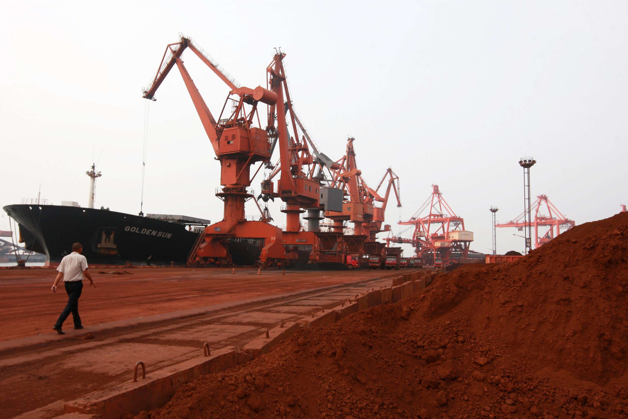 CORRECTING CREATION DATE Bulldozer scoop soil containing various rare earth to be loaded on to a ship at a port in Lianyungang, east China's Jiangsu province on September 5, 2010, for export to Japan. (Photo credit should read STR/AFP via Getty Images)