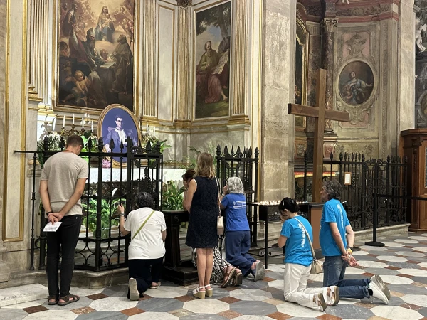 Faithful pray at Pier Giorgio Frassati’s tomb while marking the centenary of his death in Turin, Italy, Friday, July 4, 2025. Credit: Courtney Mares/CNA