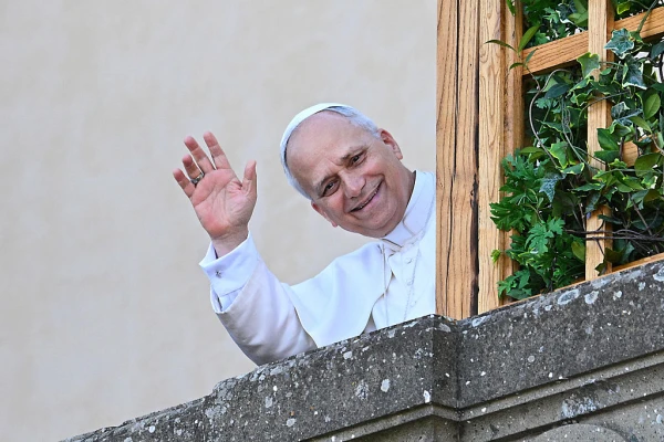 Pope Leo XIV waves to the people from the terrace of the summer papal estate where he arrives for a two-week stay in Castel Gandolfo, 40 km southeast of Rome, on July 6, 2025. Credit: ANDREAS SOLARO/AFP via Getty Images