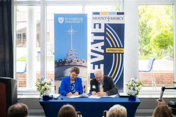 St. Ambrose University President Amy Novak (left) and Mount Mercy University President Todd Olson (right) at the June 27, 2025, Milestone Celebration. Credit: Zyon Velázquez/St. Ambrose University