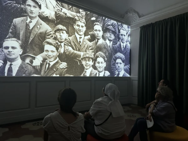 Visitors watch an exhibit at the new multimedia museum dedicated to the life of Pier Giorgio Frassati in Turin, Italy. Credit: Courtney Mares/CNA