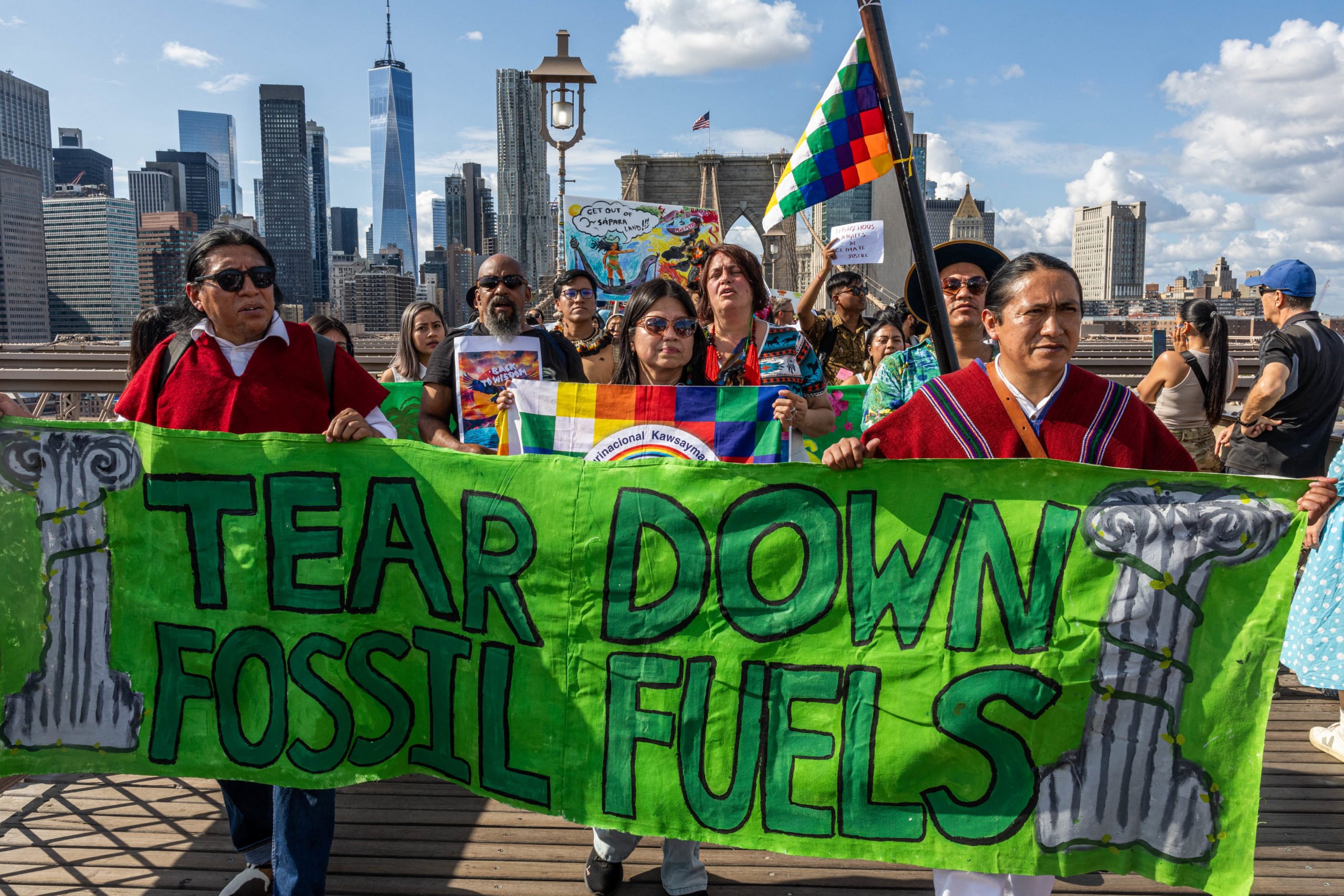 TOPSHOT - People cross the Brooklyn Bridge calling for leaders to
