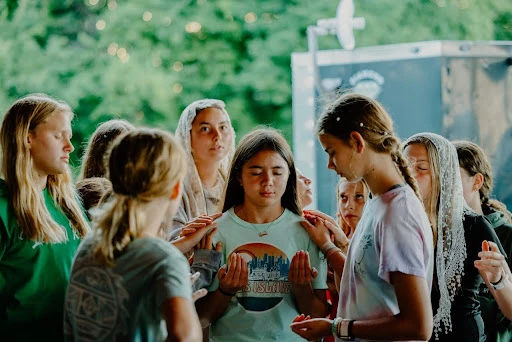 A small group of middle schoolers pray with each camper during Thursday night adoration in 2024 at the Damascus main campus, Centerburg, Ohio. Credit: Photo courtesy of Damascus Media Staff