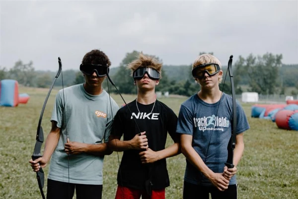 Three middle school campers play archery tag, a high-adventure activity in 2024 at Damascus' main campus, Centerburg, Ohio. Credit: Photo courtesy of Damascus Media Staff