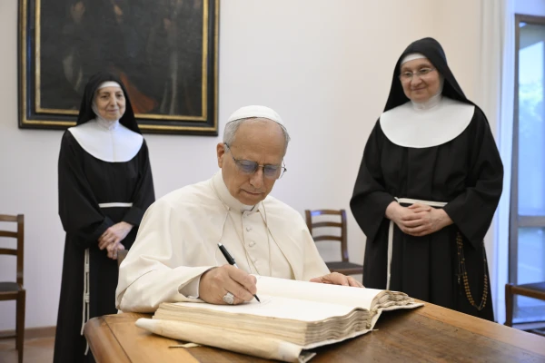 Leo XIV signed the sisters' book of guests of honor. Credit: Vatican Media