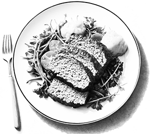 Sliced meatloaf on salad with mashed potatoes.