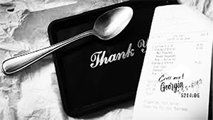 Receipt and thank you card with spoon on tray.