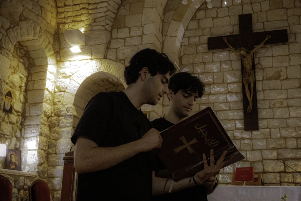 Charbel and Giovanni Lteif read the Bible in a church where they were filming content for their Instagram page. Credit: Photo courtesy of Charbel and Giovanni Lteif