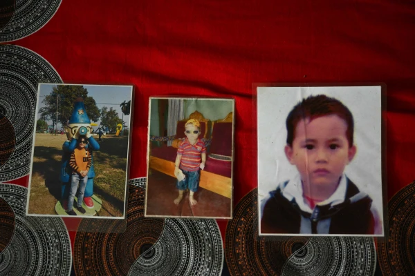 Photos of Ukya Chhaing Marma on display at his family's house in Bandarban, Bangladesh, July 26, 2025. The 14-year-old died after a Bangladesh Air Force training jet crashed into his school on July 21. Credit: Piyas Biswas