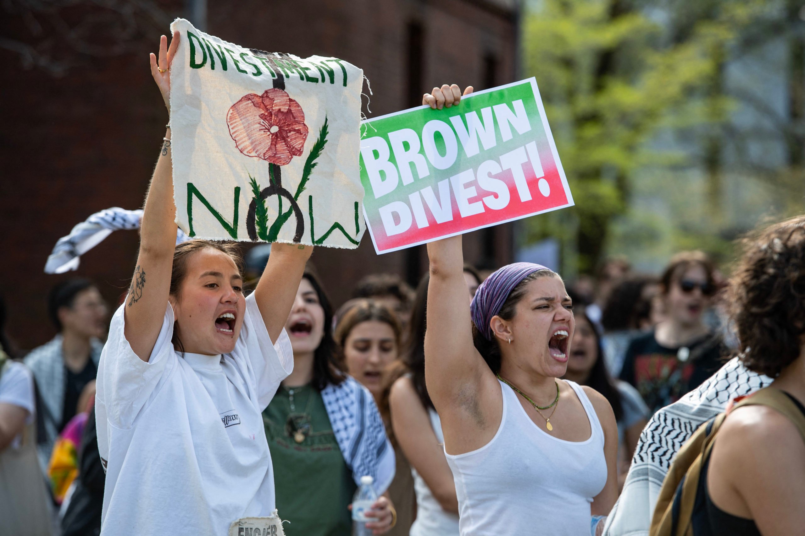 Pr0-lestinian protestors rally as they march around university hall at the pro-Palestinian encampment at Brown University (Photo by JOSEPH PREZIOSO/AFP via Getty Images)