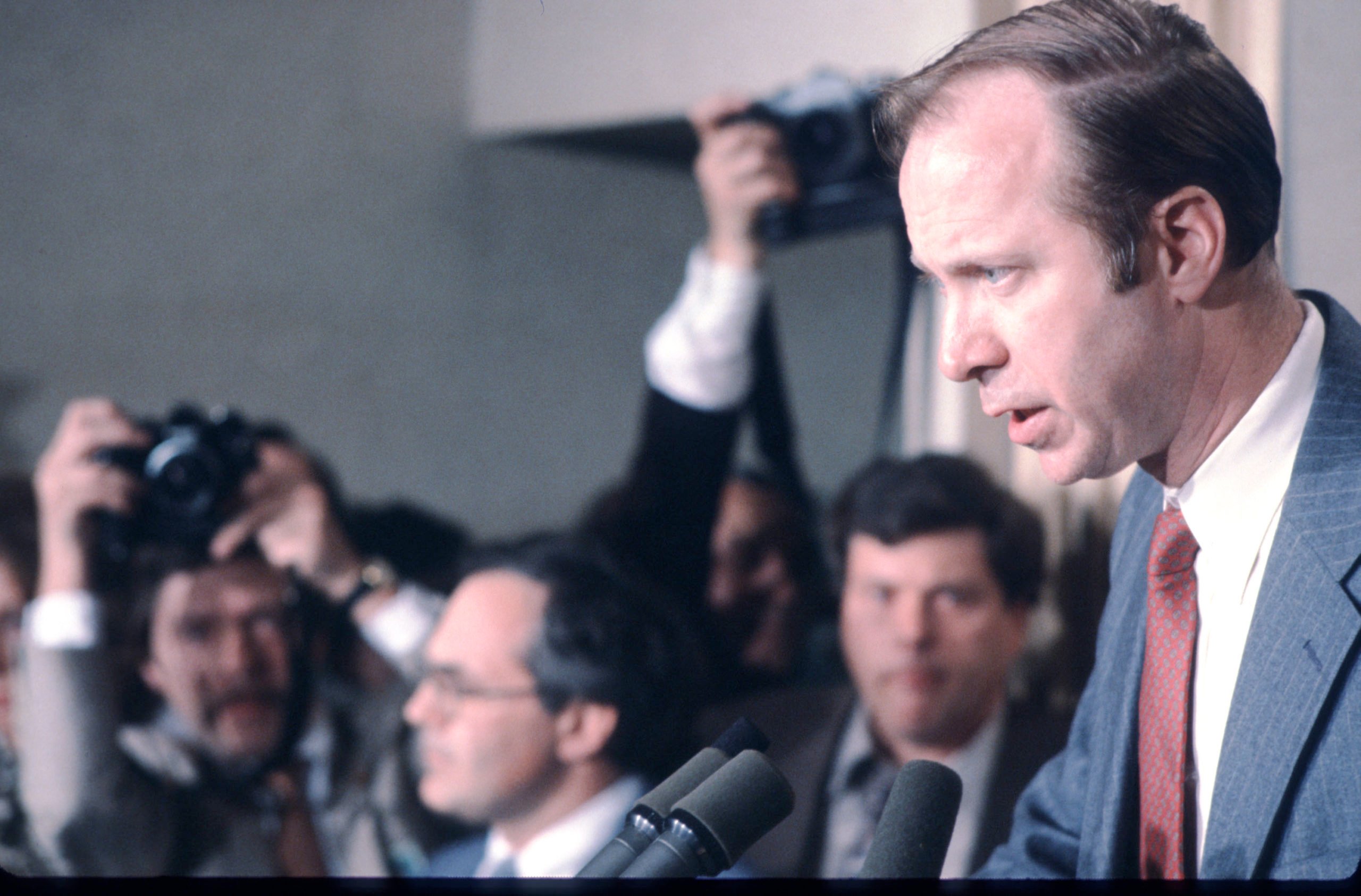 21851_11: White House Advisor David Gergen answers questions March 31, 1981 at a press conference in which Secretary of State Alexander Haig Jr. announced that he would assume executive authority over the country in Washington, DC. Haig asserts that the Constitution places him next in line to the Presidency since Vice President Bush was away in Texas during the attempt to assassinate President Reagan. 