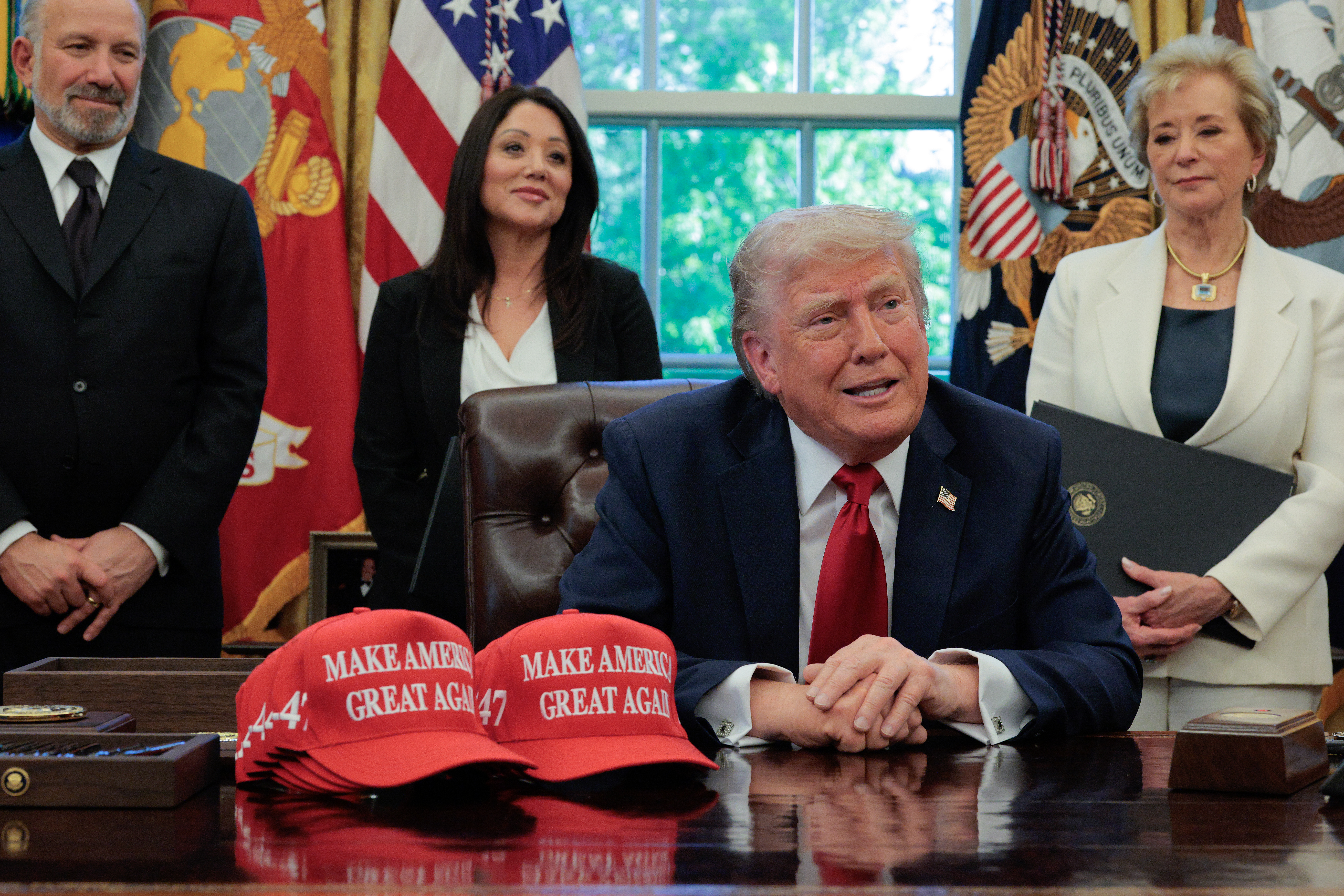 WASHINGTON, DC - APRIL 23: U.S. President Donald Trump speaks to the media as (L-R) Secretary of Commerce Howard Lutnick, Secretary of Labor Lori Chavez-DeRemer and Secretary of Education Linda McMahon look on after signing executive orders in the Oval Office at the White House on April 23, 2025 in Washington, DC. The seven executive orders were related to education policy including enforcing universities to disclose foreign gifts, artificial intelligence education and school disciplinary policies. (Photo by Chip Somodevilla/Getty Images)