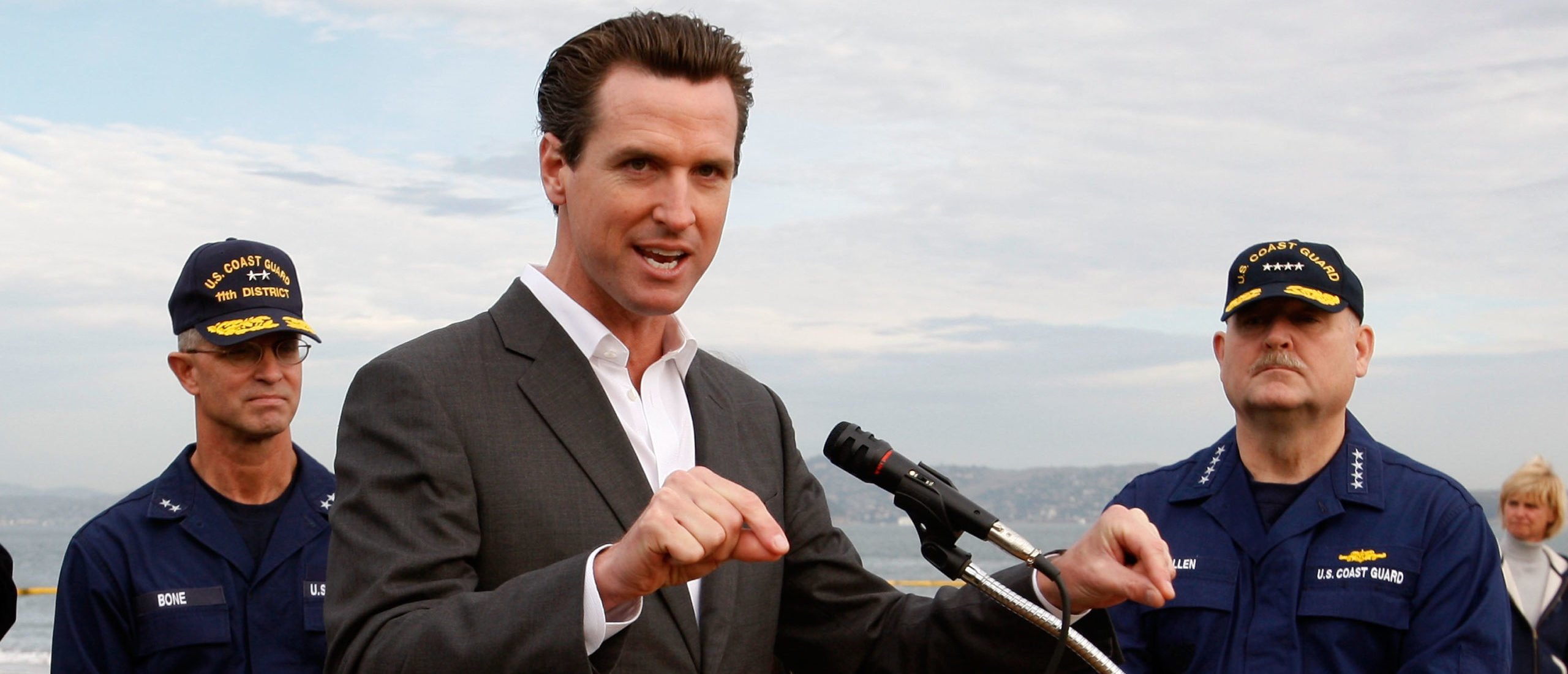 San Francisco mayor Gavin Newsom (C) speaks to reporters as U.S. Coast Guard commandant Thad Allen (R) and U.S. Coast Guard Rear Admiral Craig Bone look on after touring the oil affected beach at Crissy Field November 12, 2007 in San Francisco, California. (Photo by Justin Sullivan via Getty Images)