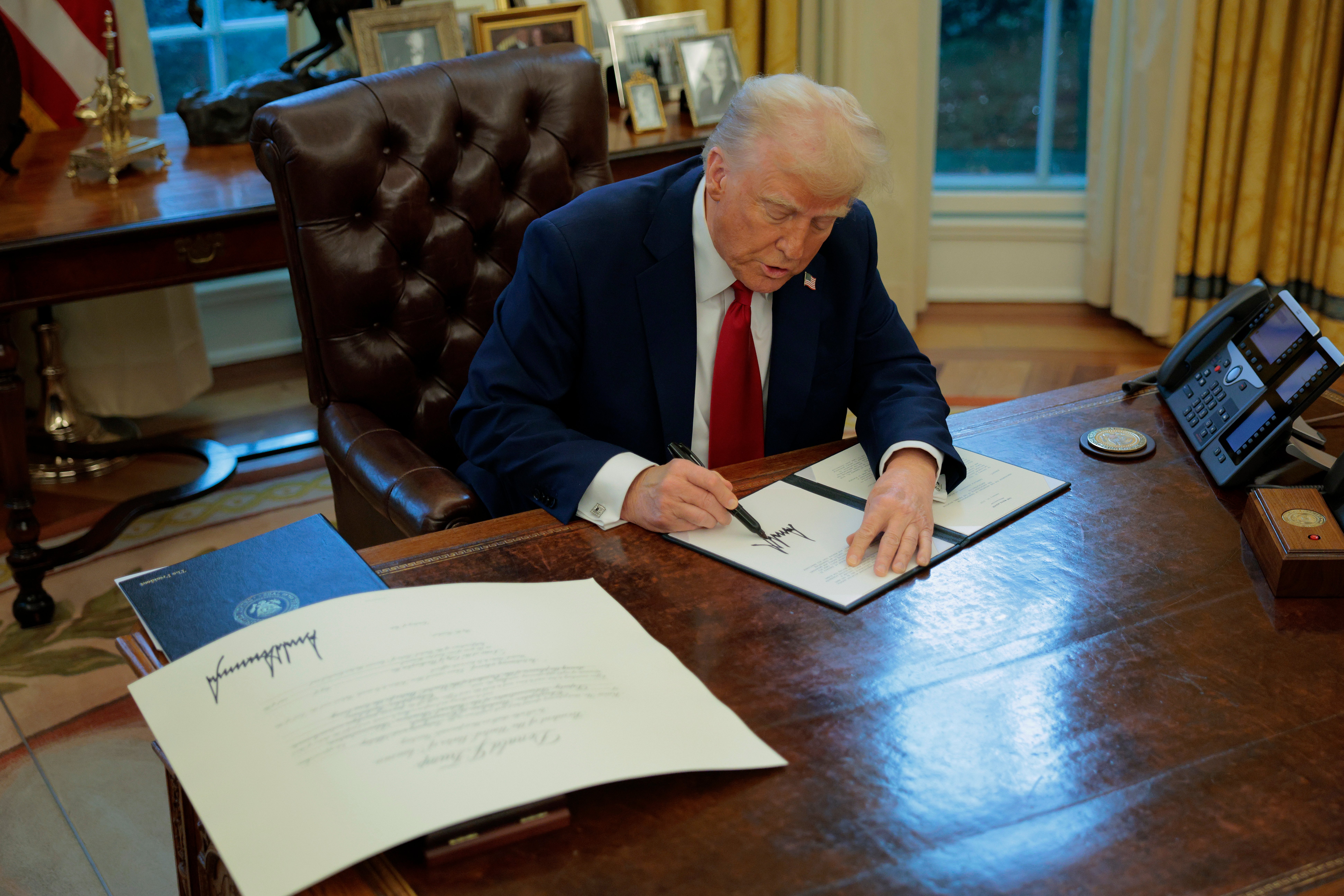 WASHINGTON, DC - JANUARY 30: U.S. President Donald Trump signs a memorandum ordering an immediate assessment of aviation safety and ordering an elevation of what he called “competence” over “D.E.I.” in the Oval Office at the White House on January 30, 2025 in Washington, DC. (Photo by Chip Somodevilla/Getty Images)