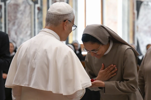 Pope Leo XIV greets a woman religious during an audience with members of the Sisters of the Order of St. Basil the Great, the Daughters of Divine Charity, the Augustinian Sisters of the Amparo, and the Franciscan Sisters of the Sacred Hearts, on June 30, 2025, at the Vatican. Credit: Vatican Media